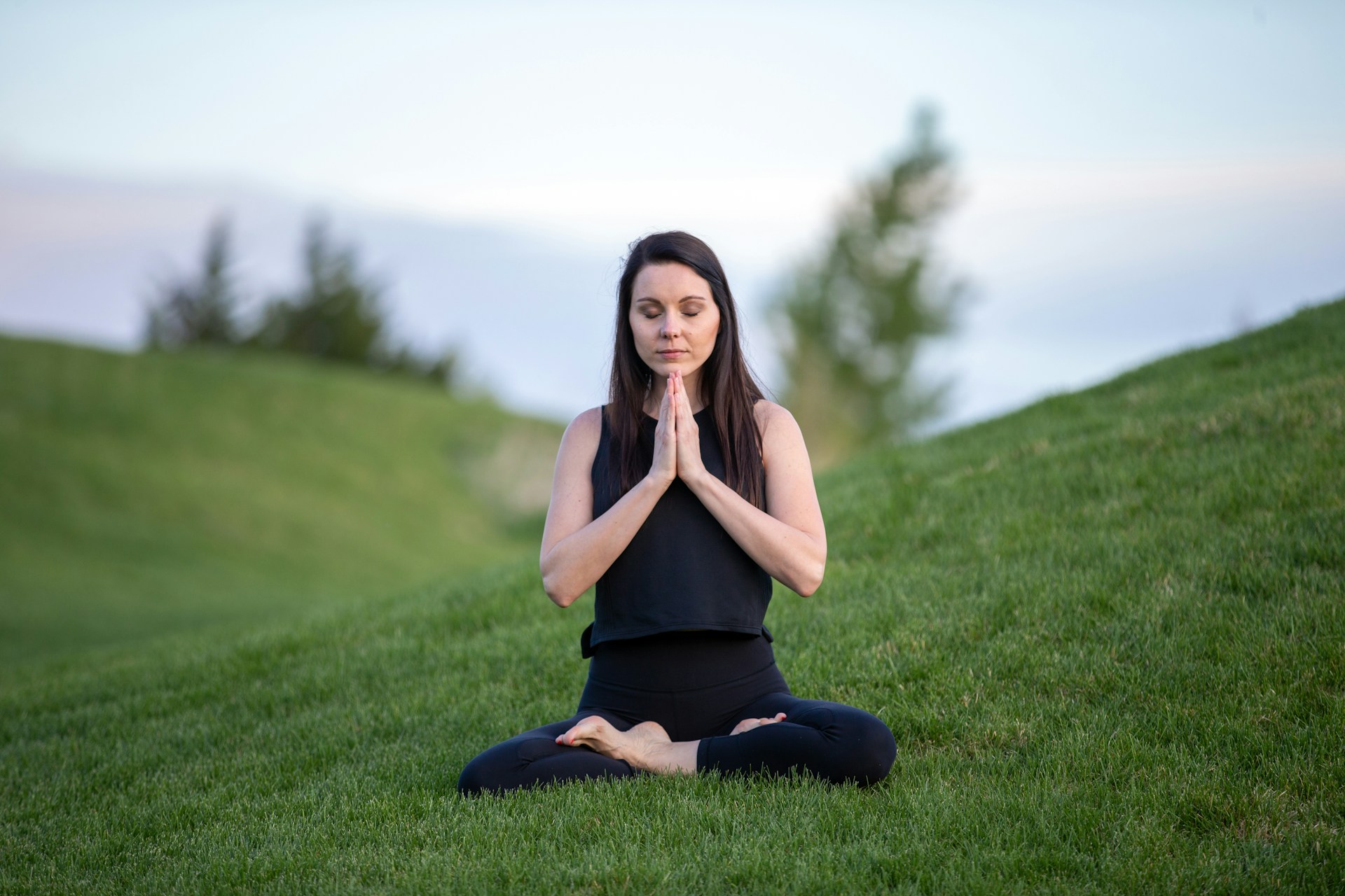 Yoga Woman Green Field doing meditation