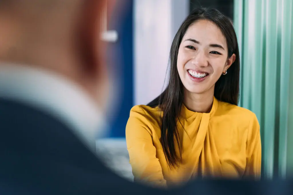 Coach in conversation with a client across a desk