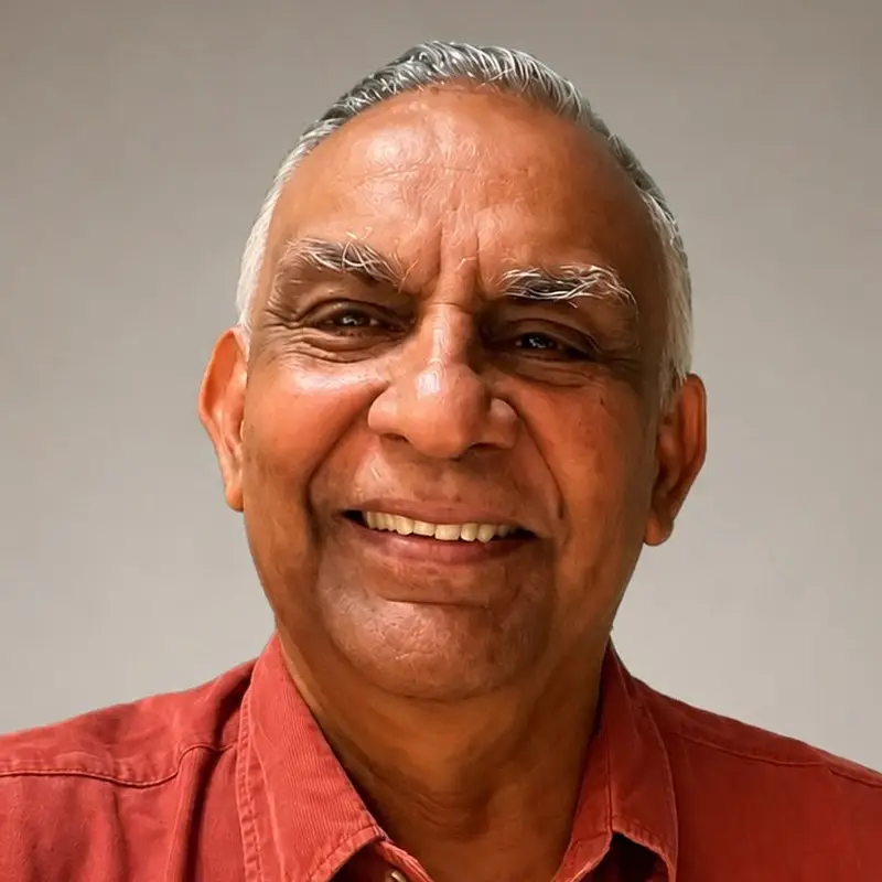 Ram Ramanathan, Coacharya cofounder and board member, smiling in a red button-up shirt
