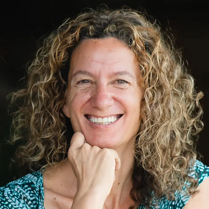 Tracy Brown, Marketing Director at Coacharya, smiling with her chin resting on her hand