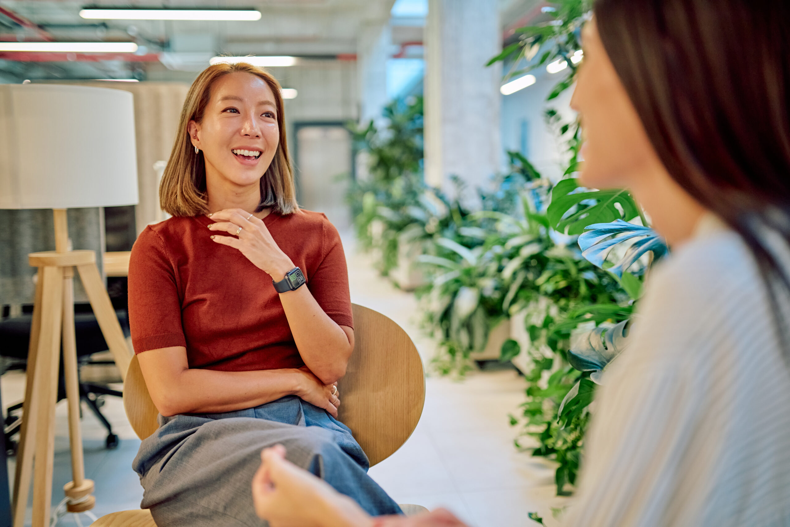 Two women in a one-on-one conversation in a bright open space